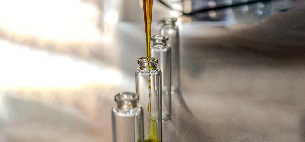 Picture of Fish Oil beingfilled into small glass bottles.